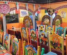 Mexican art chairs adorn dining room